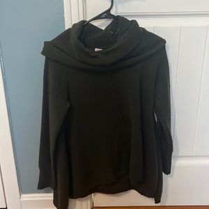 Women’s olive green sweater with scoop neck and slit sides.